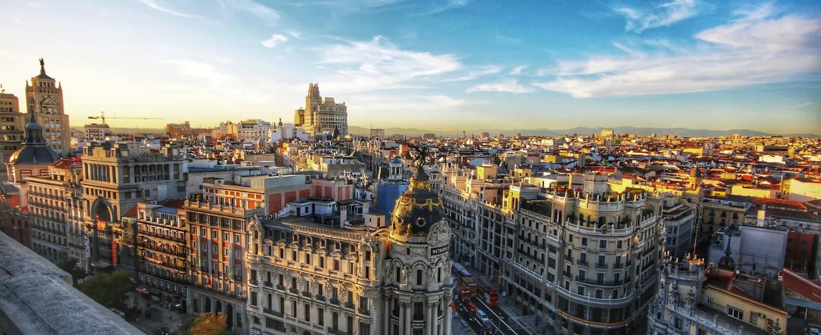 Vista panorámica del skyline de Madrid al atardecer, con la Gran Vía y el edificio Metrópolis