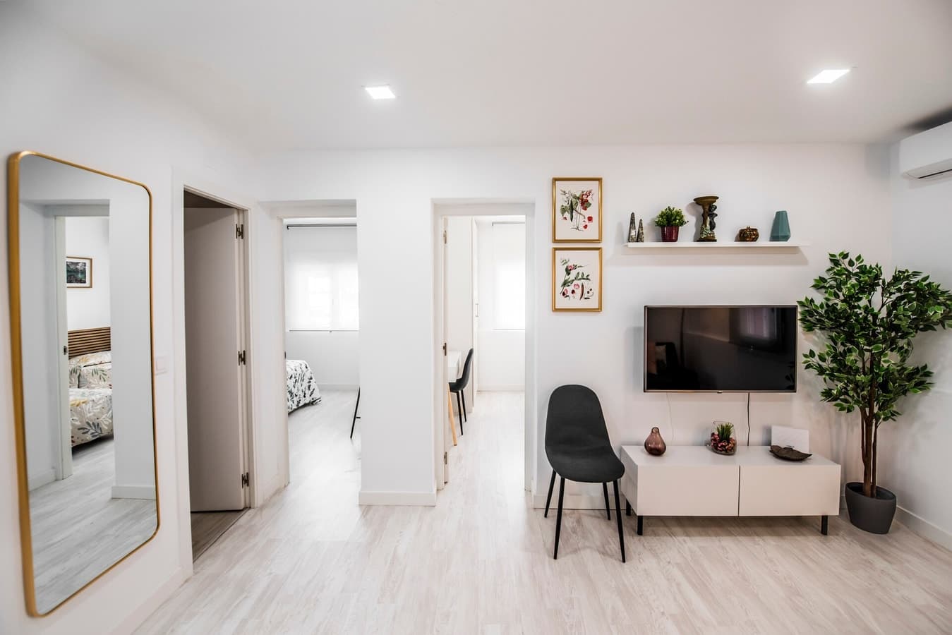 Bright living room of a property managed by beBalmy, with the hallway and bedrooms at the back