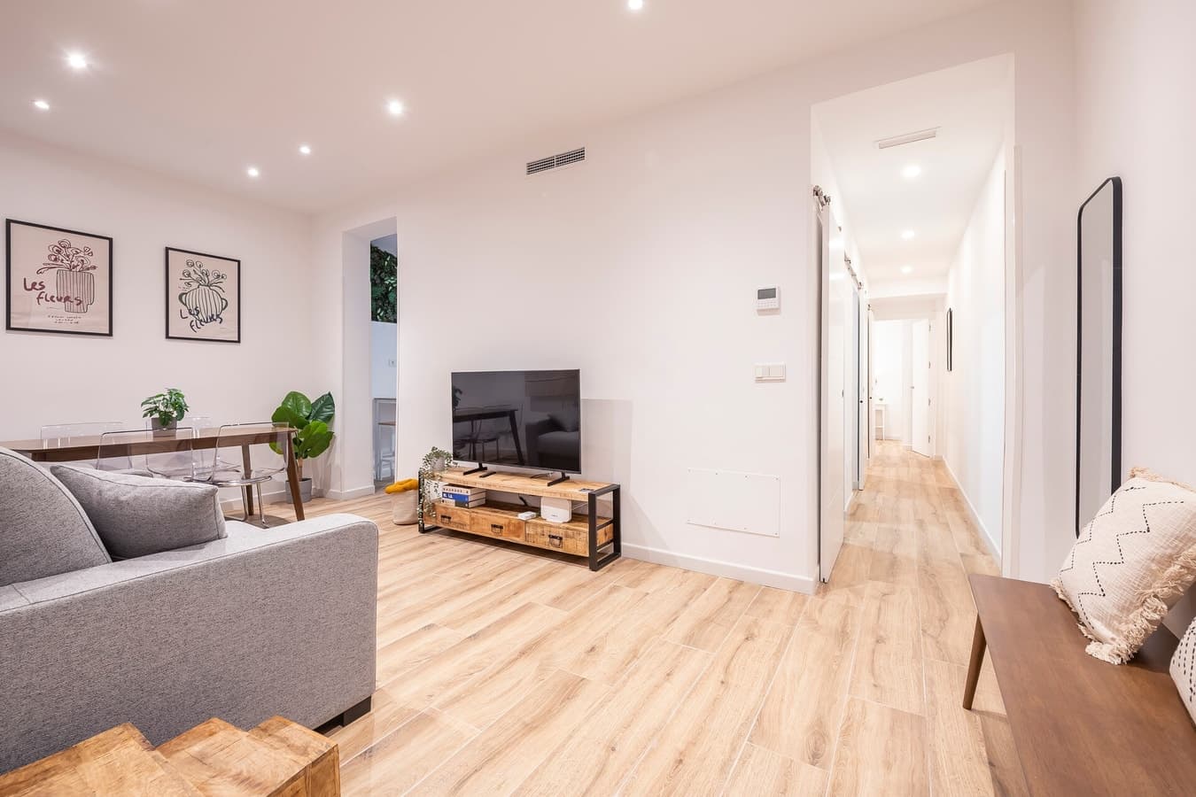 Living room of a managed property, with the hallway behind