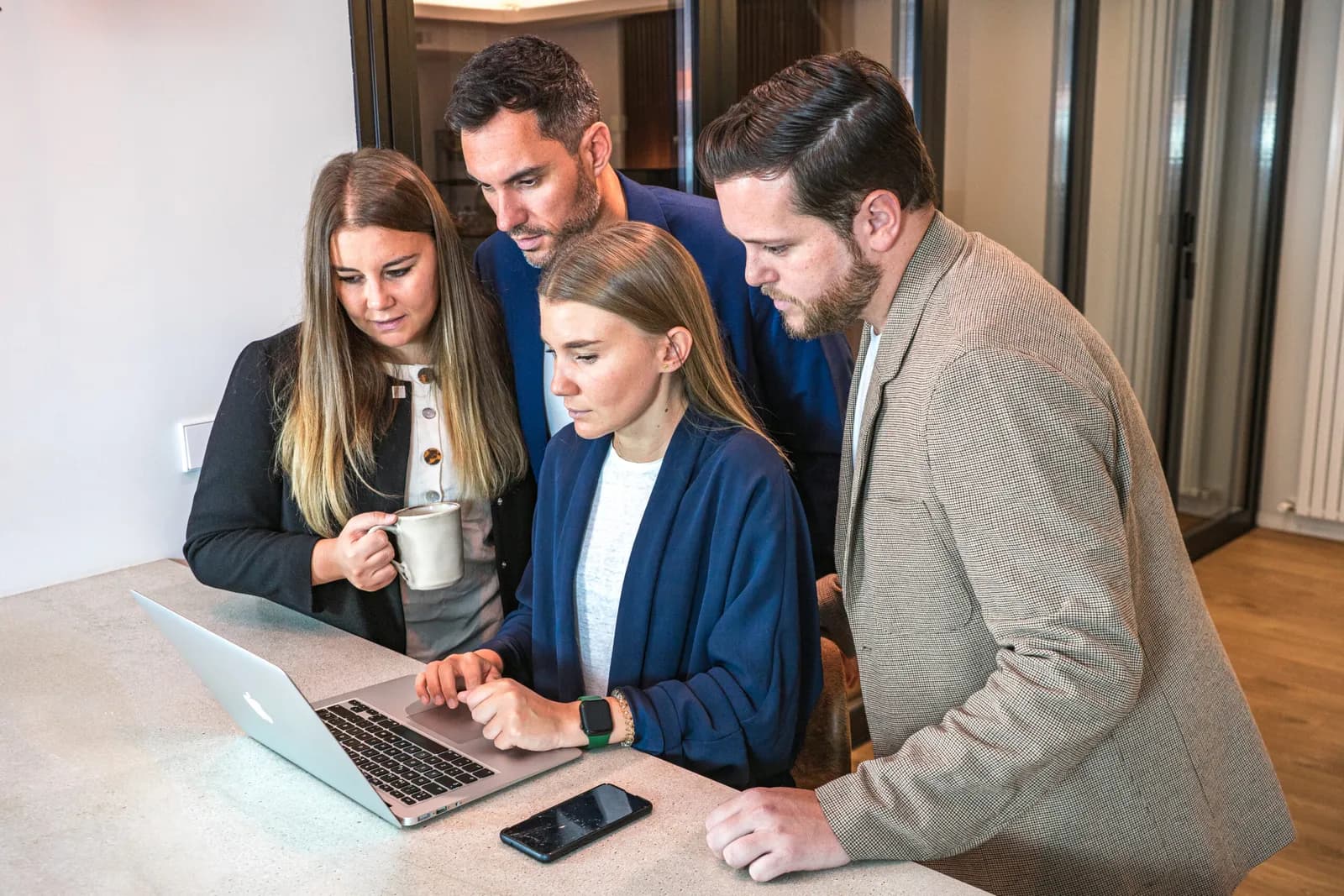 Four beBalmy partners going through the management of a property together on a laptop
